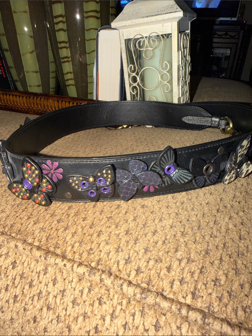 A Coach Black Leather Floral Applique Strap with beautiful butterflies